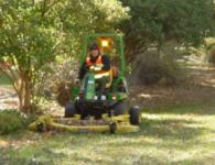 Worker Mowing Grass